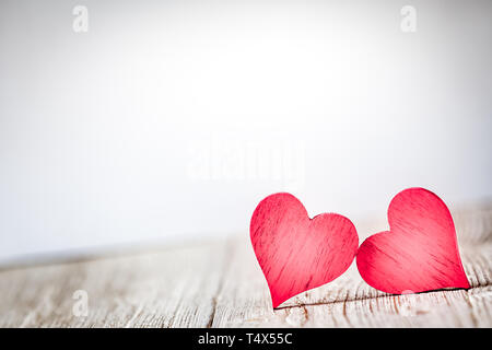 Two red hearts on wooden background Stock Photo