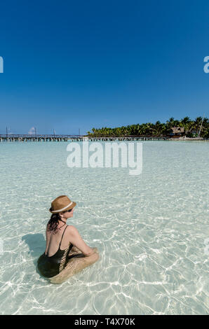 woman relaxing in the beach of Punta Norte, Isla Mujeres Stock Photo