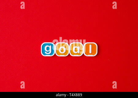 GOAL word block on RED background. Stock Photo