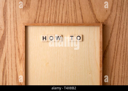 HOW TO word block on wood background. Stock Photo