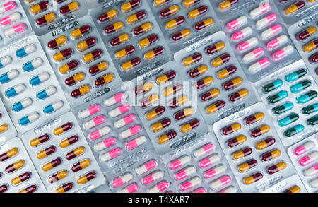 Top view of colorful antibiotic capsule pills in blister pack. Antibiotic drug resistance. Pharmaceutical industry. Pharmacy drug store background. Gl Stock Photo
