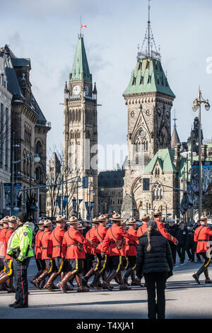 OTTAWA, CANADA - NOVEMBER 11, 2018: Royal Canadian Mounted Police, RCMP, or Mounties, in formal red uniform, standing during remembrance day in front  Stock Photo