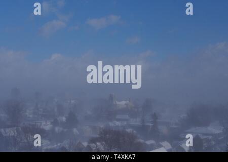 Despite a clear blue sky, a snow squall blankets downtown Ottawa during ...