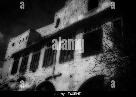Old Facade in Black and White. A facade and old windows within an Abandoned Building in black and white. Stock Photo
