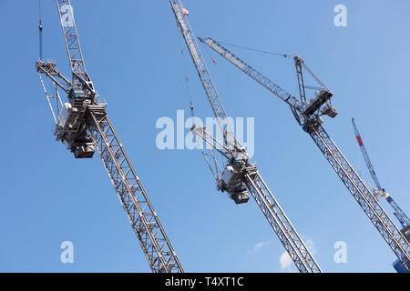 Tower cranes against a blue sky Stock Photo
