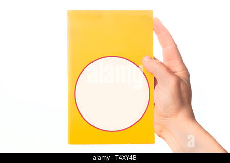Man hand holding a crime novel book with blank cover on white background Stock Photo