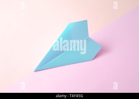 paper airplane on pastel background. Minimal flat lay school concept. Stock Photo