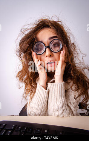 Funny nerd girl working on computer Stock Photo