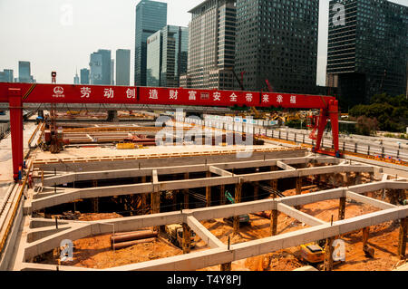 Subway construction at Gangxia North station in central Shenzhen with Shennan Avenue dug up. Stock Photo