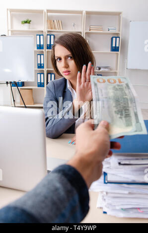 Beautiful female employee unhappy with excessive work Stock Photo