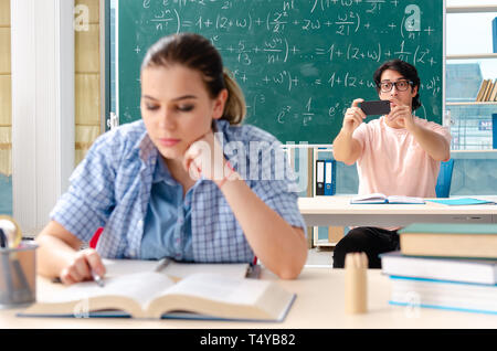 Young students taking the math exam in classroom Stock Photo