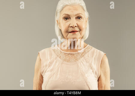 Nice positive aged woman posing for a photo Stock Photo