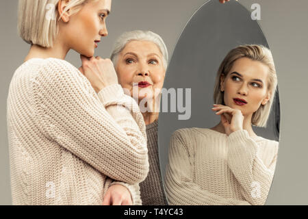 Nice magnetic blonde woman touching her chin Stock Photo