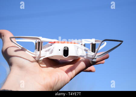 New technology in the aero photo shooting. Pilot launches quadrupter from his palm. Stock Photo