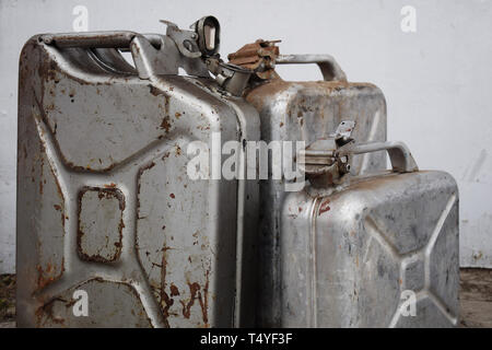 Three gray cans with gasoline petrol or diesel, metal barrel Stock Photo