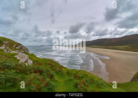 Rows of Breakers and waves coming on to the golden beach of Rhossili Bay on the Gower Peninsula on a wet windy Summers Day. South Wales. Stock Photo