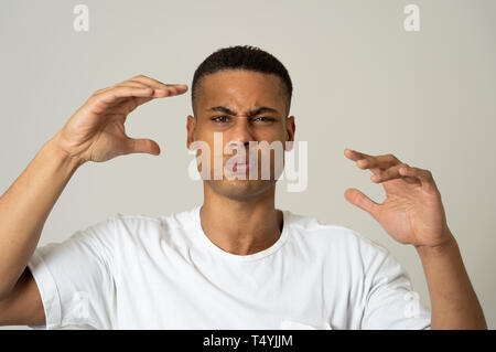 Portrait of young african american man feeling scared and shocked. Disgusted at something that is happening. In horror and violence social issue. Huma Stock Photo