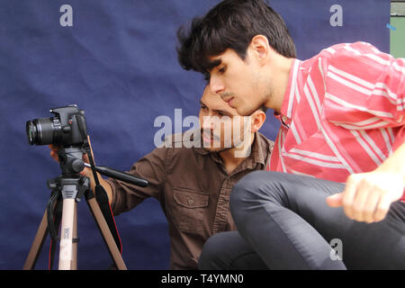 Merida, Venezuela - July 6, 2017: Unknown male photographers setting their camera. Stock Photo