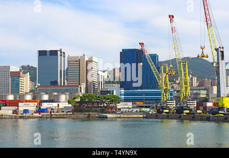 GENOA, ITALY - View from the sea of the Genoa harbor with modern buildings, cranes, docks and gasometers Stock Photo