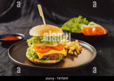 Homemade burger and cheese with fries and icy soft drink Stock Photo