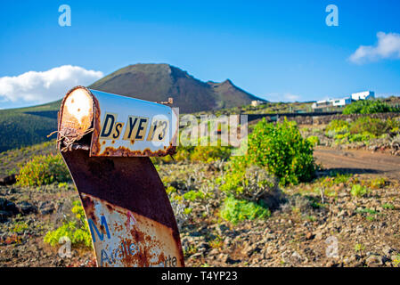 Old and rusty abandoned mailbox in the countryside of the island of Lanzarote, Spain Stock Photo