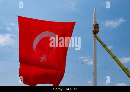 Istanbul, Turkey - June 17, 2016: Big Turkish flag hoisted in public place in Istanbul. Stock Photo
