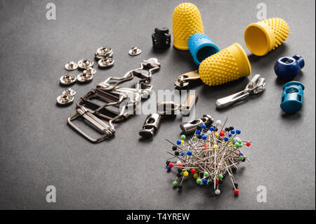 thimble and sewing pins on dark backdround Stock Photo