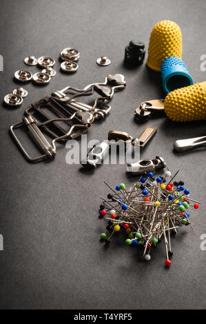 thimble and sewing pins on dark backdround Stock Photo