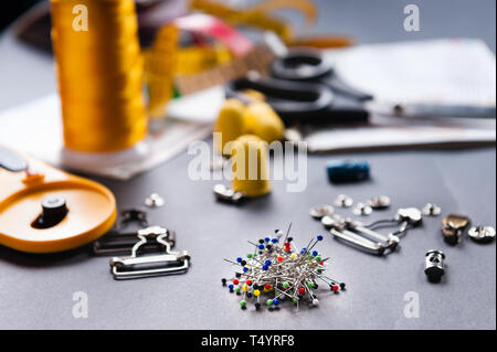 thimble and sewing pins on dark backdround Stock Photo