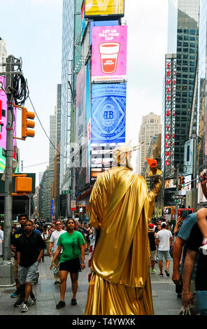 New York City, New York, USA 2016-05-29: back view of staue of liberty impersonator on crowded street at Times Square Stock Photo