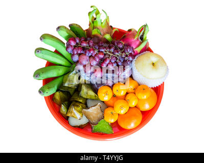 Various fruits and dessert on red tray in chinese festival,isolated on white background Stock Photo