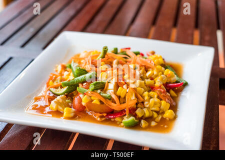 Corn seeds with fruits and vegetables sour spicy in white plate Stock Photo