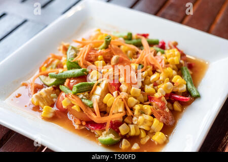 Corn seeds with fruits and vegetables sour spicy in white plate Stock Photo