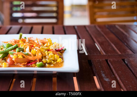 Corn seeds with fruits and vegetables sour spicy in white plate Stock Photo