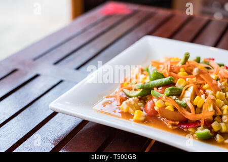 Corn seeds with fruits and vegetables sour spicy in white plate Stock Photo