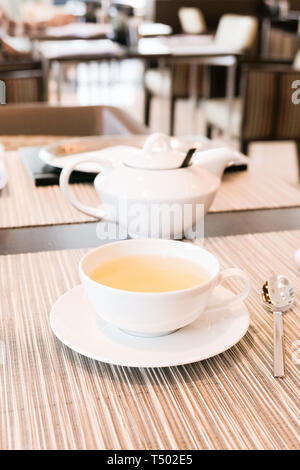 Healthy nutrition, relax and detox concept - Green herbal tea in a restaurant, five o'clock Stock Photo