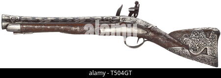 An Ottoman silver-mounted flintlock blunderbuss, 19th century. Round, funnel-shaped barrel with rich silver inlays on top and smith's mark at the breech. Slightly engraved (somewhat pitted) flintlock. Walnut stock profusely inlaid with silver wire and ornamentally embossed silver fittings as well as an implied silver ramrod. Length 54 cm. historic, historical, Ottoman, Orient, Oriental, Asia, Asian, 19th century, Additional-Rights-Clearance-Info-Not-Available Stock Photo