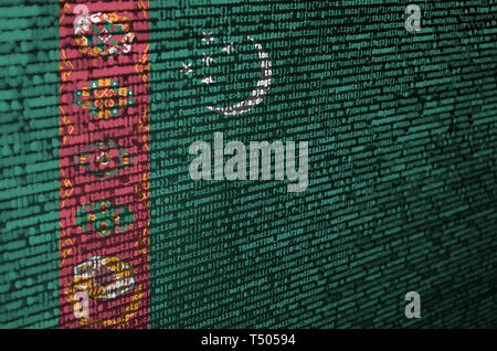 Turkmenistan flag  is depicted on the screen with the program code. The concept of modern technology and site development. Stock Photo