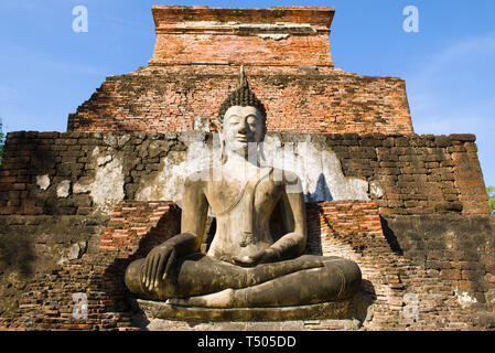 Ancient sculpture of a sitting Buddha close-up. Ruins of the Buddhist temple Wat Mahathat. Sukhothai, Thailand Stock Photo