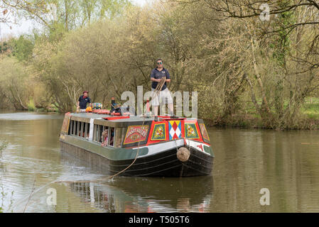 Kintbury, Berkshire, England, UK. A narroboat used for passenger canal trips on the Kennet and Avon Canal in Berkshire. Skipper holding mooring line Stock Photo