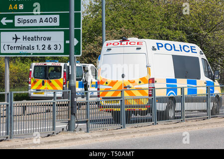London, UK. 19th April, 2019. Police vehicles pass along the A4 outside Heathrow airport following a small protest earlier by Extinction Rebellion Youth. A large police presence is evident around the airport but so far any disruption feared by the airport authorities from Extinction Rebellion climate change activists has been symbolic rather than material. Credit: Mark Kerrison/Alamy Live News