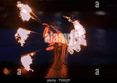 London, UK. 19th Apr, 2019. A member of the 'London Fire Spinners' group of acrobats, fire eaters, fire spinners and jugglers practices his spinning skills on the Thames River beach in London's South Bank. (in-camera multiple exposures) Credit: Imageplotter/Alamy Live News Stock Photo