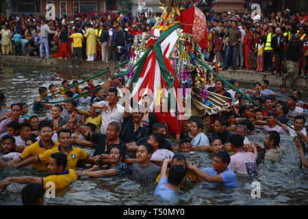 Kathmandu, Nepal. 20th Apr, 2019. Nepalese people carry a chariot on a pond during Gahana Khojne festival in Kathmandu, Nepal on Saturday, April 20, 2019. It is believed that once upon a time four Goddesses lost their jewels and a frantic search ensued in search till now in the pond of lost jewels. Credit: Skanda Gautam/ZUMA Wire/Alamy Live News Stock Photo