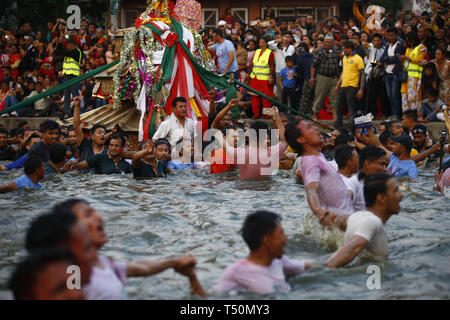 Kathmandu, Nepal. 20th Apr, 2019. Nepalese people carry a chariot on a pond during Gahana Khojne festival in Kathmandu, Nepal on Saturday, April 20, 2019. It is believed that once upon a time four Goddesses lost their jewels and a frantic search ensued in search till now in the pond of lost jewels. Credit: Skanda Gautam/ZUMA Wire/Alamy Live News Stock Photo