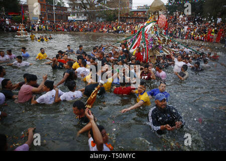 Kathmandu, Nepal. 20th Apr, 2019. Nepalese people carry a chariot on a pond during Gahana Khojne festival in Kathmandu, Nepal on Saturday, April 20, 2019. It is believed that once upon a time four Goddesses lost their jewels and a frantic search ensued in search till now in the pond of lost jewels. Credit: Skanda Gautam/ZUMA Wire/Alamy Live News Stock Photo