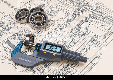 Micrometer screw gauge. Ball bearings. Drawing on background. Accurate measuring tool. Digital display. Round metal parts group. Engineering design. Stock Photo