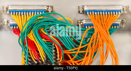 Mechanic rotary switch. Parallel cables. Connectors centronics. Analog to digital signal transmission. Insulated wires. Tangled colored cords bunches. Stock Photo