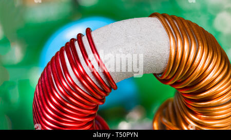 Toroidal transformer detail. Coil winding. Copper wire. Magnetic ferrite core. Colorful inductor. Inverter electronic part. Inductance. Electrotechnic. Stock Photo