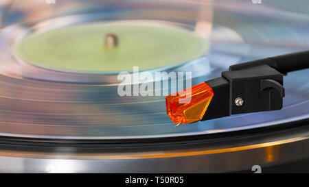 Gramophone pickup arm. Phonograph record. Retro turntable. Rotating sound storage medium. Grooved vinyl disc. Stylus detail. Old stereo player. Music. Stock Photo
