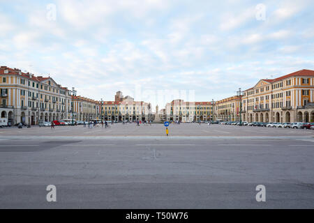 CUNEO, ITALY - AUGUST 13, 2016: Central Galimberti square with people, wide angle view at dusk, blue sky in Cuneo, Italy. Stock Photo